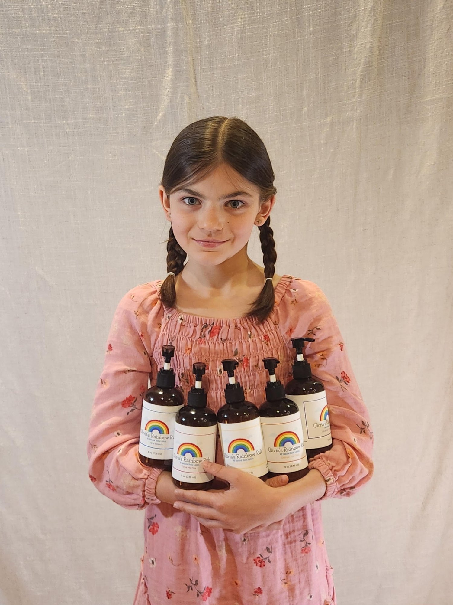 Olivia Holding Rainbow of Lotions Olivia Holding Rainbow of Lotions